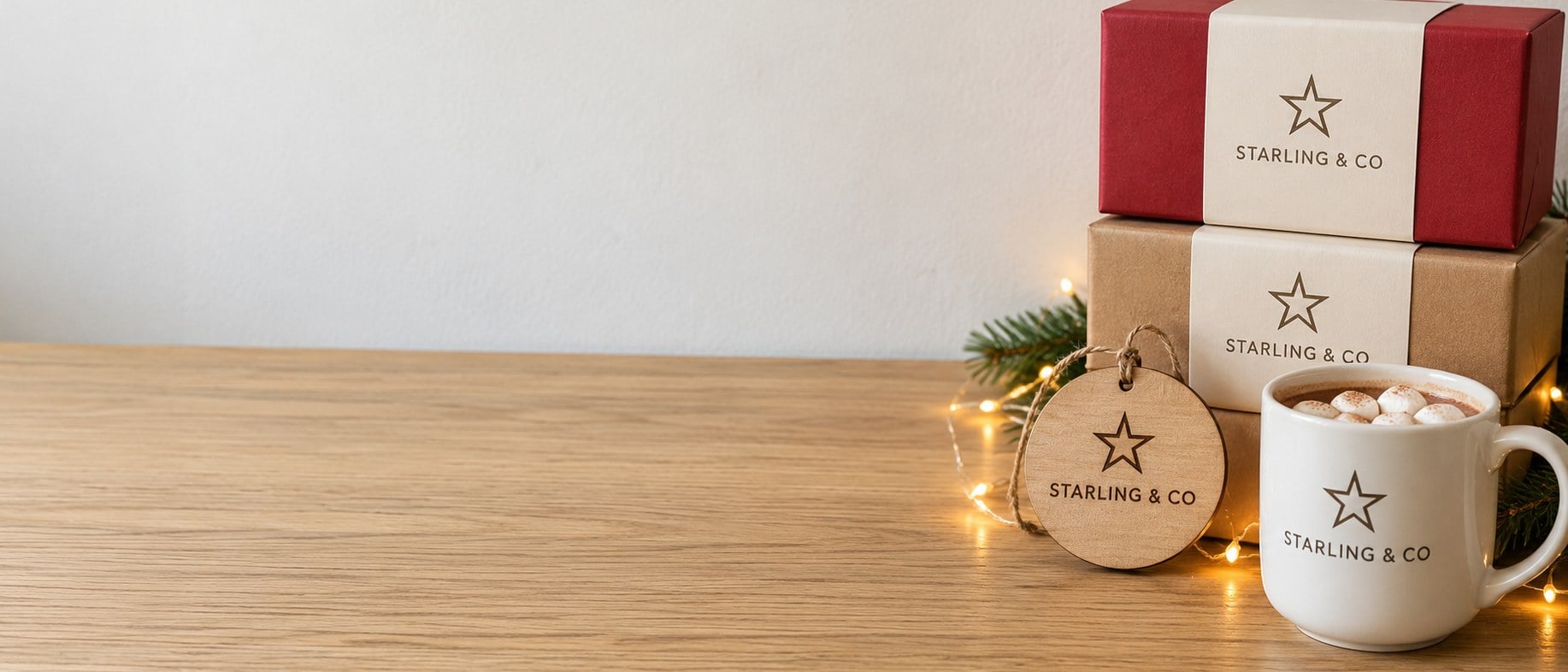 Custom branded Christmas gifts and gift boxes on a wooden table